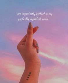 a woman's hand with a small tattoo on her wrist and the words i am perfectly perfect in my perfectly imperfect world