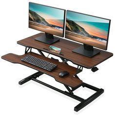 a computer desk with two monitors and a keyboard on top of it, in front of a white background