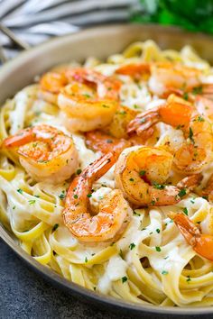 pasta with shrimp and parmesan cheese in a bowl