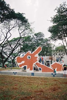 two people standing in front of a colorful sculpture