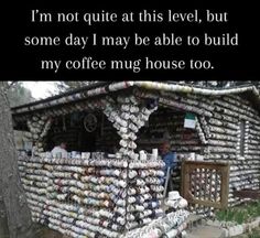 a house made out of coffee mugs with the words i'm not quite at this level, but some day i may be able to build my coffee mug house too