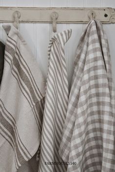 three towels hanging on a coat rack