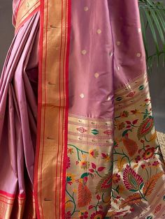 Wear this gorgeous dusty pink paithani silk saree and become the cynosure of all eyes. Crafted with meticulous attention to detail, this stunning saree is perfect for weddings, receptions, functions, and any other event where you want to be the center of attraction.
Made from high-quality silk material, this saree boasts a rich and luxurious dusty pink color. The zari weaving work adds a touch of elegance and sophistication, making it a truly exquisite piece. The saree also features an elegant r Pink Meenakari Saree For Diwali, Pink Paithani Silk Traditional Wear With Patterns, Pink Paithani Silk Traditional Wear With Traditional Patterns, Pink Traditional Wear With Paithani Silk And Traditional Patterns, Pink Paithani Silk Traditional Wear For Navratri, Pink Paithani Silk Traditional Wear For Eid, Pink Meenakari Saree For Traditional Ceremonies, Pink Meenakari Saree For Navratri, Pink Meenakari Traditional Wear For Festivals