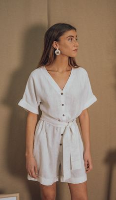 OUR GAELLE LINEN JUMPSUIT IS ELEGANT AND COMFY AT THE SAME TIME. YOU CAN WEAR IT  LOOSE OR CINCHED AT THE WAIST. BUTTONED FRONT, WIDE PATTERN AND SIDE POCKETS.THE PERFECT PIECE FOR ALL YOUR SUMMER WANDERINGS! BLUE ANEMONE IS A SUSTAINABLE, ETHICAL AND ARTISANAL BRAND, ALL OUR STYLES ARE HANDMADE USING THE BEST SUSTAINABLE MATERIALS LIKE LINEN, COTTON,HEMP AND RAMIE. ALL OUR ORDERS ARE CUSTOM MADE TO AVOID GENERATING OVERSTOCKS AND MORE WASTE TO OUR BELOVED PLANET ALL OUR CLOTHES ARE ETHICALLY PR White Summer Jumpsuit With Tie Waist, Chic Linen Jumpsuits And Rompers For Day Out, White Jumpsuit With Tie Waist For Day Out, White Tie Waist Jumpsuit For Day Out, White V-neck Jumpsuit With Tie Waist, Elegant Linen Jumpsuits And Rompers For Beach, White Linen Beach Jumpsuits And Rompers, Chic Linen Jumpsuits And Rompers With Short Sleeves, Chic Linen Jumpsuits And Rompers With Tie Waist