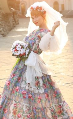 a woman in a dress with flowers on her head