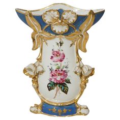 an ornate vase with flowers painted on the side and gold trimming around the edges