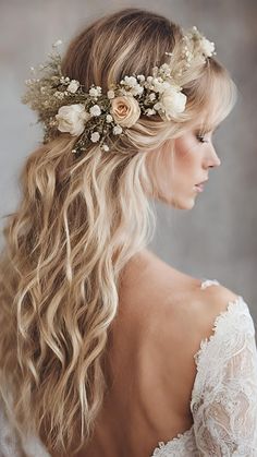 a woman with long blonde hair and flowers in her hair is wearing a white dress