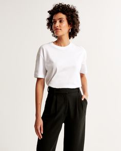 Elevate your casual wardrobe with the Abercrombie & Fitch Women's Essential Premium Polished Oversized Tee. This tee is designed to offer both comfort and style with its heavyweight softAF fabric and biopolish finish, ensuring a crisp feel every time you wear it.

- Size: XS
- Color: White
- Material: Cotton
- Gender: Female
- Fit: Oversized
- Neckline: Crew
- Hem: Straight

Perfect for a relaxed day out or a cozy evening at home, this tee pairs effortlessly with your favorite jeans or leggings, Essentials Clothing, Active Swimwear, Swimwear Suits, Cozy Evening, Clothing Staples, Women Essentials, Boyfriend Tee, Clothing Essentials, Oversized Tee