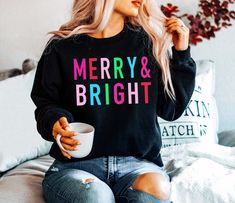 Christmas Shirts for Women Long Sleeve Christmas Sweatshirt for women, Merry and Bright Shirt, Cute Christmas Tshirt, Christmas Crewneck * SHIPS in 1 Business Day! * UNISEX cozy sweatshirts & tees are soft and durable!  * Shop with Confidence! We are a 5-Star Rated Shop operating since 2015! * Easy measuring tip: Take your favorite sweatshirt or tee, lay it on a flat surface and measure the width (armpit to armpit) and length (top to bottom), then compare with our size chart!  * Unisex, classic Cute Winter Sweaters, Christmas Crewneck, Letter Print Sweatshirt, Unique Holiday Gifts, Funny Christmas Shirts, Black Sweatshirt, Women Sweater, Loose Outfit, Holiday Sweater