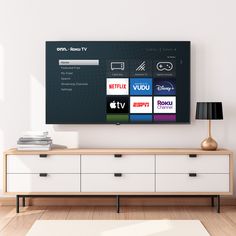 a flat screen tv sitting on top of a wooden dresser