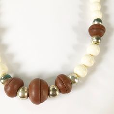 90s beaded necklace Brown leather, white and gold beads on a double brown string. String ties at the back of the neck The necklace is 30 inches long Some of the gold beads are tarnished, hence the low price. Otherwise the necklace is in good condition. Everyday Brown Jewelry With Large Beads, Adjustable Brown Necklace With Large Beads, Retro Brown Handmade Necklaces, Adjustable Beaded Brown Choker, Handmade Retro Brown Necklaces, Adjustable Brown Beaded Choker, Retro Brown Beaded Jewelry, Retro Handmade Brown Necklaces, Adjustable Brown Vintage Necklace