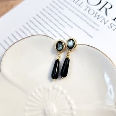 These Black dangle earrings, Black onyx teardrop and mother of pearl earrings, Black earrings, Vintage style earrings, Gold framed earrings  are so elegant and pretty. They are made with black onyx tear drop beads (6X16mm) and gold-framed black mother of pearl posts. The needles are 925 silver.  Each earring features a lustrous mother-of-pearl centerpiece, encased in a delicate gold-tone frame that exudes Victorian charm. The interplay between the mother of pearl and the sleek onyx teardrop-shaped pendant creates a timeless sophistication to the design.  The earrings are approximately 1.5 inches.  It is a wonderful gift for yourself or your loved one. Due to hygiene reasons, earrings are not returnable or exchangeable. All purchases above $35 will be shipped through USPS ground advantage f Black Pearl Earrings For Formal Occasions, Classic Black Pearl Drop Earrings, Black Dangle Pearl Earrings For Formal Occasions, Elegant Black Pearl Drop Earrings, Elegant Black Pearl Earrings, Black Drop Pearl Drop Jewelry, Black Pearl Drop Jewelry, Black Pearl Drop Earrings For Formal Events, Black Pearl Drop Earrings For Evening