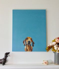 a painting of a dachshund dog on a blue background next to a vase with flowers