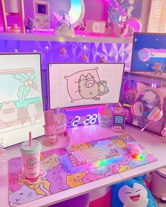 a desk with two computer monitors, keyboard and cup on it in a room filled with toys