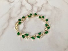 This emerald coloured bracelet has been created with AAA grade cubic zirconia crystals , this piece is fully adjustable so will fit most wrists.     An Ideal gift for most occasions but would especially suit the Bride, Bridesmaids, Mother of the Bride or even wedding guests !  All my bridal accessories are made to the very highest standard using the finest quality materials whilst paying care and attention to detail. Materials  . Sparkling finest AAA grade cubic zirconia crystals  . Emerald coloured cubic zirconia crystals  . Measures 16.5cm but can be extended to 20cm with an extender which is     included . Ships worldwide from West Wales in the U.K.  Cubic zirconia is similar to a diamond with its brilliance and crystal clarity, but it is a man-made material that is, hard, and flawless Green Cubic Zirconia Bracelet For Gift, Elegant Green Crystal Bracelets, Green Crystal Bracelets For Wedding, Green Cubic Zirconia Bracelets For Wedding, Green Crystal Bracelet For Wedding, Green Diamond Bangle Bracelet For Wedding, Green Diamond Bangle For Wedding, Green Crystal Bracelet For Weddings, Green Crystal Wedding Bracelet