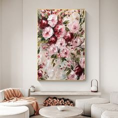 a living room filled with white furniture and a painting on the wall above a fire place