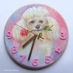 a clock with a painting of a poodle holding a rose on it's face