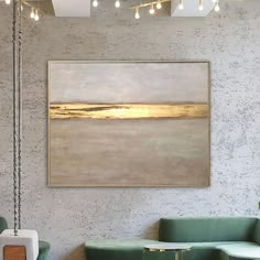 a painting hanging on the wall above a green couch