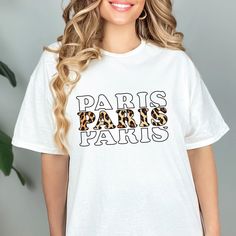 "Paris Shirt, France Gift, Print Leopard T shirt, Leopard Print Tee, French T-shirt, Paris Trip Tee, Animal Cheetah Print Shirt, Animal Lover Looking for cute Paris Leopard Shirts?🇫🇷 Then the France T-shirts are perfect for you! The Paris Shirts will also be Great Paris Trip Gifts for Friends and Family who loves Paris France. Get the Leopard Paris Tee Shirts now️ We offer Worldwide Free Shipping🚚💕 Check out our New Arrivals💕 https://www.etsy.com/shop/BHENRYstyle .: 100% cotton (fiber content may vary for different colors) .: Medium fabric (5.3 oz/yd² (180 g/m .: Classic fit .: Tear-away label .: Runs true to size .: Unisex 👑Classic Fit: Comfort Fit (Boxy and Roomy) 👑Retail Fit: Slim Fit (more Form-Fitting Lines around the Shoulders, Arms, and Torso) 💫Different styles of shirts may Trendy Leopard Print T-shirt For Spring, Trendy Cotton T-shirt In Leopard Print, Leopard T Shirt, Leopard Shirts, Cotton Leopard Print T-shirt For Summer, Cheetah Print Shirt, Cheetah Print Shirts, Trendy Leopard Print Graphic T-shirt, Paris Tee