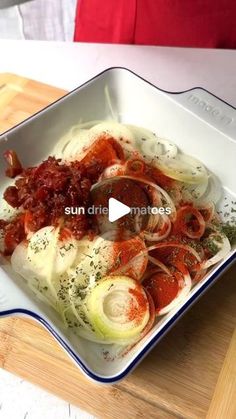 a white bowl filled with food on top of a wooden cutting board