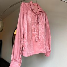 Vintage Christian Dior pink silky satin monogrammed blouse.  Such a stunning piece.  Cute ribbon/tie detail around the collar and cuffed wrists.  Would best fit an xs/s to wear slightly oversized.  No tags. Ships within 48 hours. Please message me with any questions! Pink Feminine Tie Neck Top, Feminine Pink Tie Neck Top, Pink Tie Neck Top For Party, Pink Tie Neck Top For Work, Pink Satin Feminine Blouse, Pink Satin Blouse In Feminine Style, Vintage Pink Blouse For Formal Occasions, Pink Silk Collared Blouse, Elegant Pink Tie Neck Top