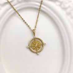 Inspired by seafaring, this unique and gorgeous carved compass pendant is crafted in 14K solid gold to be tarnish-proof and resilient for day-to-day wear. Made to Order. Ships within 3-4 weeks. - Pendant size: 22 x 17mm - Stone info: Zircon - Chain is not included and can be purchased separately. - Made in 14 karat gold. - Stamp with 14K. Compass Pendant, Jewelry Appraisal, Handmade Fine Jewelry, Gold Gift, 10k Gold, Jewelry Care, Compass, Precious Metals, Ring Earrings