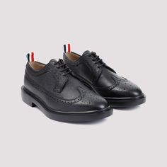 Thom Browne Longwing Black Calf Leather Brogues. Crafted from black calf leather, elongated almond toe, lace-up fastening, brogue details, grosgrain loop at the heel, leather lining, leather branded insole and outsole.Gender: MenMaterial: 100%CALF LEATHER 100%RUBBERColor: BlackMade in: ITProduct ID: MFD002H.00198_001*Import tax/duty will be calculated at checkout (If applicable) Thom Browne Shoes, Black Brogues, Leather Brogues, Caged Sandals, Black Aviators, Brogue Shoes, Balenciaga Designer, Mens Oxfords, Thom Browne