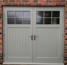 an image of a garage door that is painted in gray and has two windows on each side