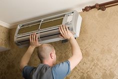 a man working on an air conditioner