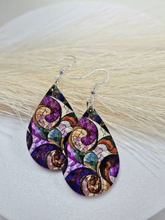 Handcrafted from durable MDF hardboard and with a glossy surface that enhances the image print. The image is printed on both sides These earrings are available in 2 sizes. Larger one measure 2.25" in length from the top of the ear wires and 1" in width. For a smaller option measuring 1.5" in length and 0.75" in width. These earrings promise a secure fit throughout the day. Hypoallergenic and with push-back stoppers for a secure fit . Each pair is elegantly packaged in a gift box, ideal for gifti Multicolor Teardrop Earrings For Gift, Multicolor Nickel-free Teardrop Earrings For Gifts, Multicolor Hypoallergenic Teardrop Earrings As Gift, Unique Multicolor Teardrop Earrings For Gift, Earring Gift, Stain Glass, Teardrop Earrings, Handmade Earrings, Ear Wires