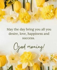 some yellow flowers are in front of a white sign with the words good morning on it