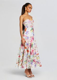 a woman in a dress with flowers on it