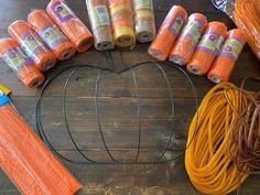 an assortment of different types of yarns on a wooden table with scissors and twine