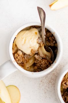 two bowls filled with apple crisp and ice cream