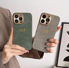 two women holding up their cell phones with the same case as they are wearing matching cases