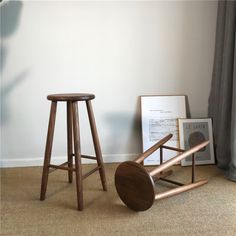 two wooden stools sitting on top of a carpeted floor