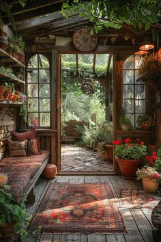 an outdoor room with lots of plants and potted plants