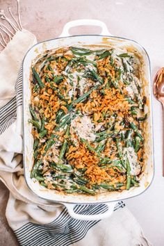 a casserole dish filled with green beans and cheese