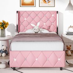 a pink bed with diamond studded headboard and foot board