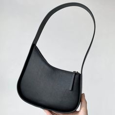 42991072936092 Black Handheld Baguette Bag For Daily Use, Black Leather Handheld Baguette Bag, Trendy Black Baguette Shoulder Bag, Modern Black Handheld Baguette Bag, Black Hobo Bag With Phone Bag For Office, Black Large Capacity Baguette Bag For Evening, Everyday Black Hobo Bag With Phone Pocket, Black Baguette Bag With Large Capacity For Evening, Black Handheld Baguette Bag With Removable Pouch