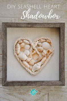 a heart made out of shells in a frame with the words diy seashell heart shadow box