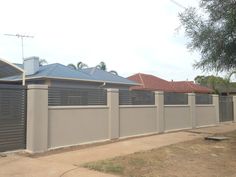 a house with a grey fence in front of it