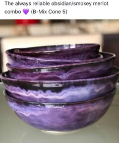 purple bowls are stacked on top of each other