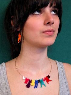 a woman with short hair wearing a colorful necklace