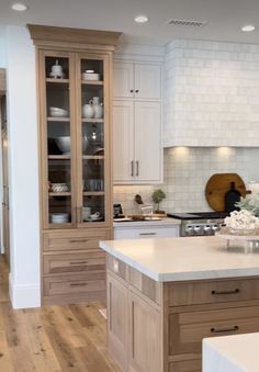 a kitchen with an island, cabinets and counter tops in the middle of the room