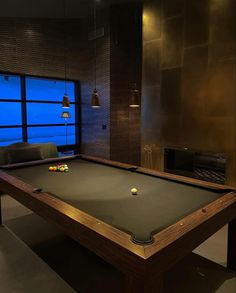 a pool table in a room with lights