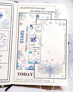 an open planner book with snowflakes and stars on the pages, sitting on top of a table