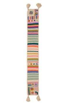 a multicolored striped rug with tassels