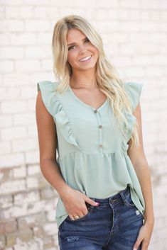 Nothing says "Hi, summer," quite like an airy top. This one's complete with smocked detailing, a v neckline and flutter sleeves. Our Jenna Ruffle Top is perfect with jeans or cut offs. Models are 5'7" and 5'8" wearing a size small Length of a small is 24" 100% Polyester Breezy V-neck Summer Top, Summer Tops With Flutter Sleeve For Brunch, Flutter Sleeve Tops For Summer Brunch, Casual Butterfly Sleeve Blouse For Summer, Trendy Summer Blouse With Flutter Sleeves, Breezy V-neck Top For Day Out, Bohemian Ruffle Sleeve Tops For Summer, Summer Brunch Tops With Butterfly Sleeves, Summer V-neck Blouse With Ruffles