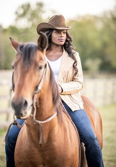 a woman riding on the back of a brown horse